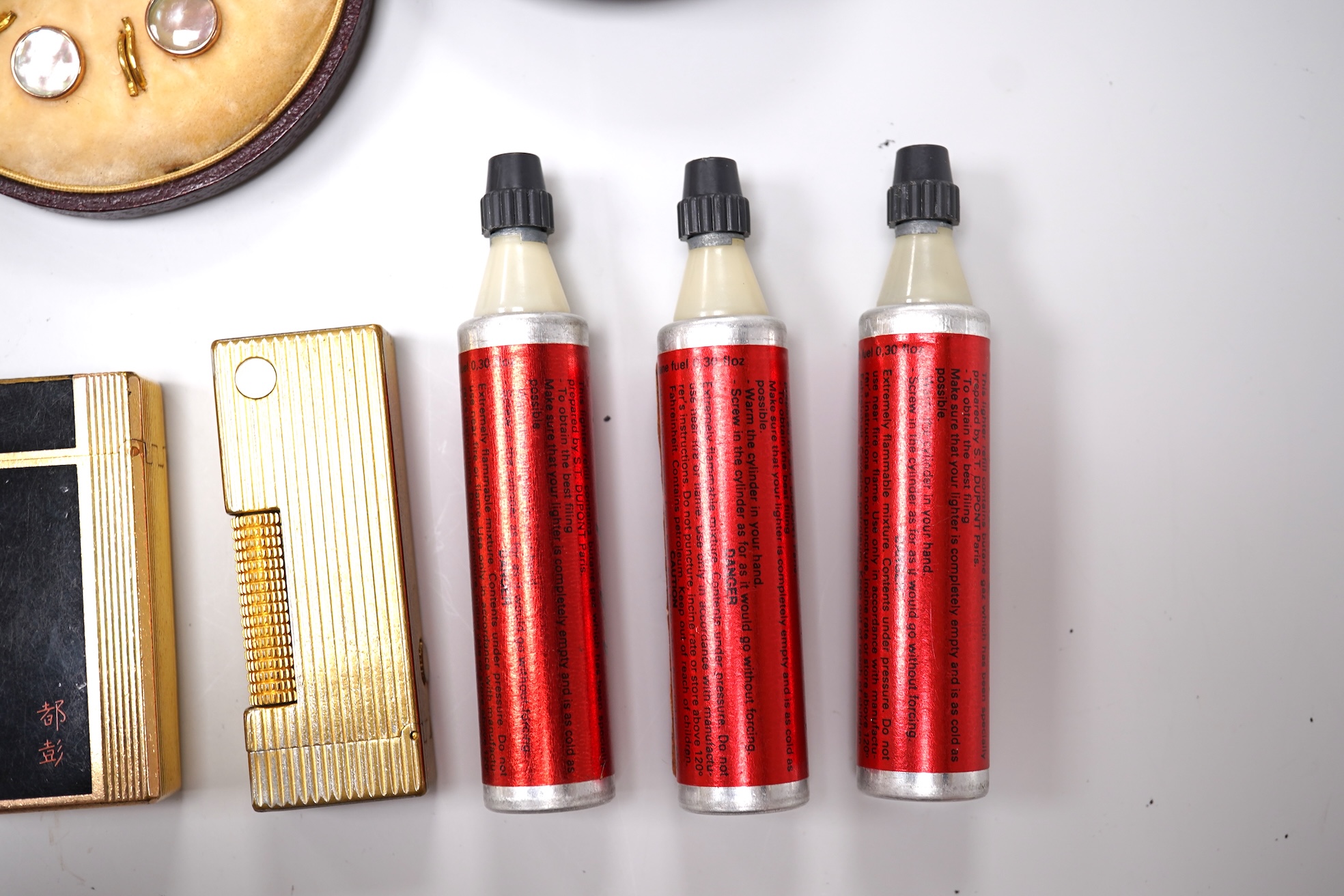 Sundry items comprising two Dupont and Dunhill lighters and cased gold and a set of cased pearl dress studs